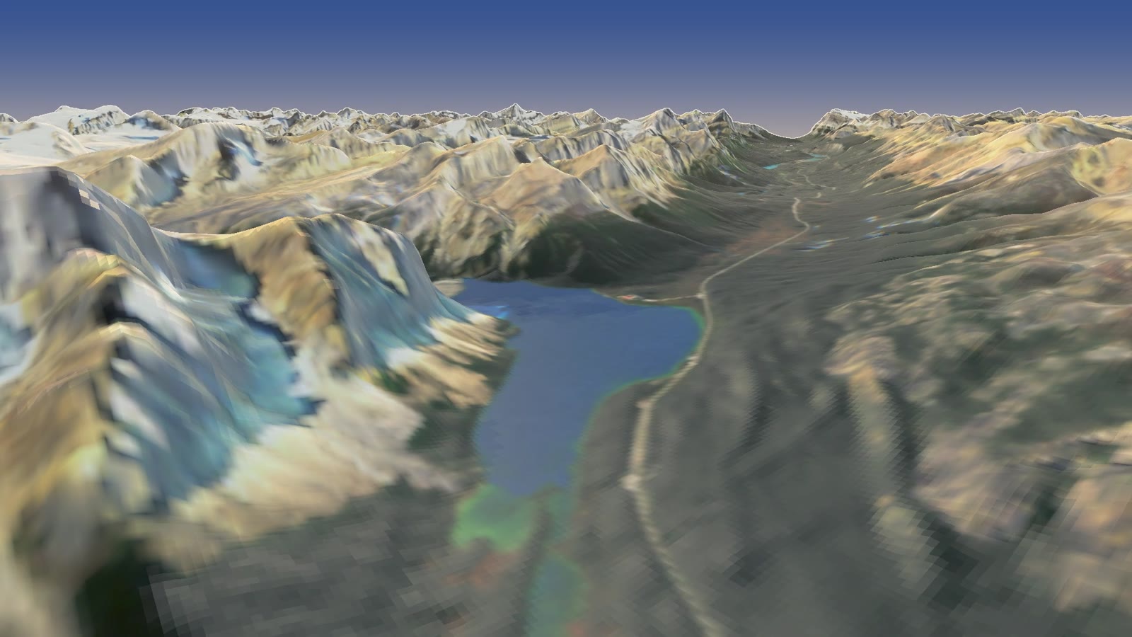 Bow Lake below the Crowfoot Glacier and Wapta Icefield, with the parkway running along the lake's eastern shore toward Bow Summit