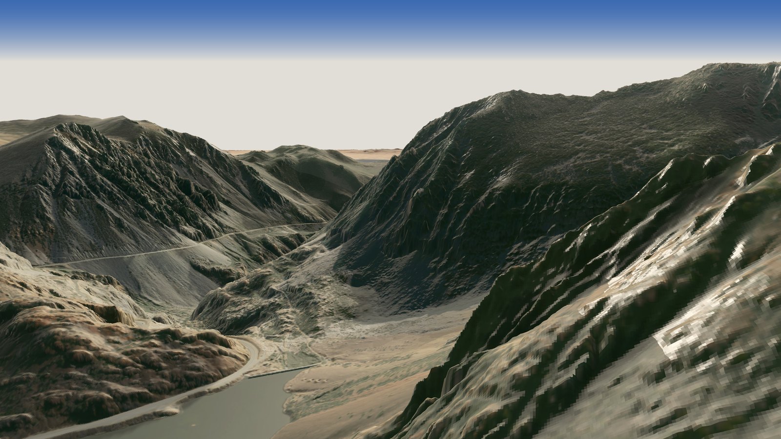Looking down the steep, dark walls at the head of Lee Vining Canyon from just below the rim, with Ellery Lake below on the left and the canyon opening toward the Mono Basin in the distance
