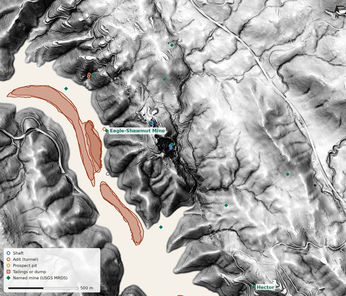 Bare-earth lidar relief of hills east of Chinese Camp, cut by a blank channel where Don Pedro Reservoir fills the canyon; brown outlines of tailings drawn on USGS topo maps from 1947 to 1973 sit out on the blank water, and a green diamond marks the Eagle-Shawmut Mine on the hill above