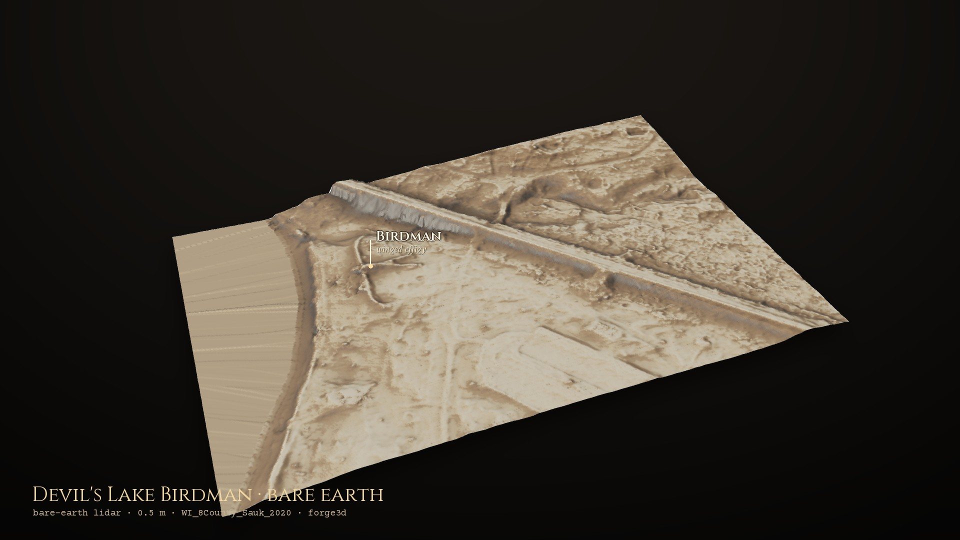 The south shore of Devil's Lake in bare-earth lidar: the winged Birdman effigy mound lies in the open ground by the lake, with the railway embankment cutting across behind it