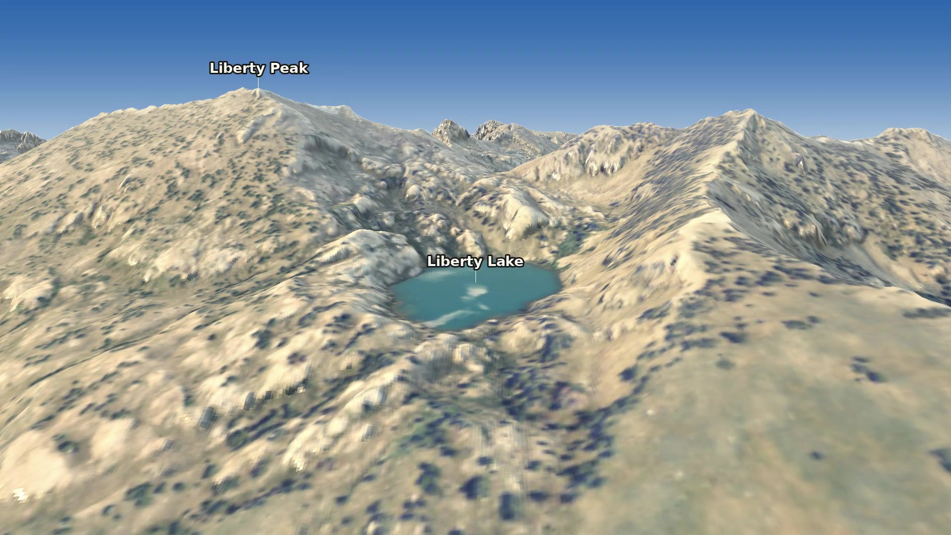 The final view from south of Liberty Lake, looking back north across the lake to Liberty Peak and Liberty Pass, with the peaks of upper Lamoille Canyon beyond