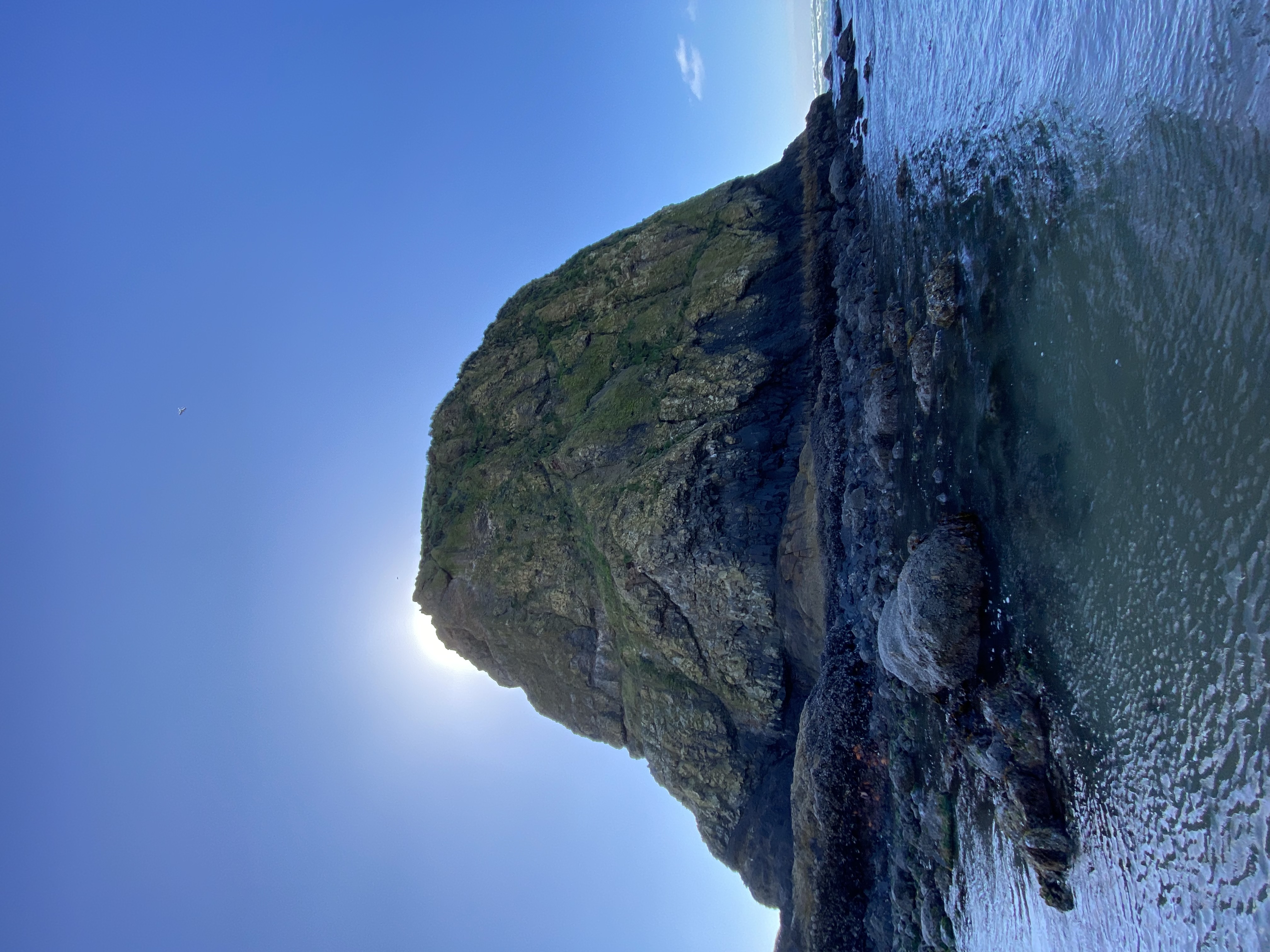 Haystack Rock from the tide pools, sun behind